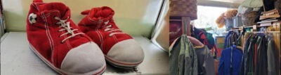 Das Bild zeigt ein Paar rote Kinderschuhe mit weißen Kappen und Fußball-Emblem, die auf einem Regal stehen. Rechts daneben ist eine Garderobe mit verschiedenen Kleidungsstücken und Körben zu sehen, die in einem Raum mit Fenster und Tageslicht untergebracht sind.